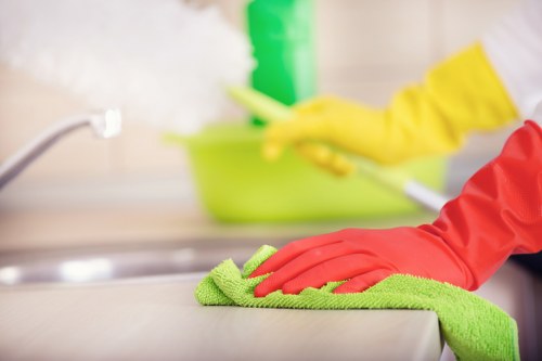 Professional cleaning team removing construction dust from a kitchen